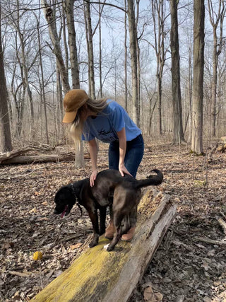 girl with dog in backgrountry