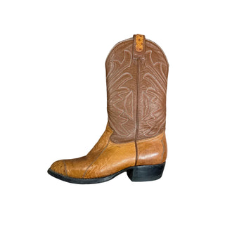 Brown leather boot with intricate patterns on a white surface