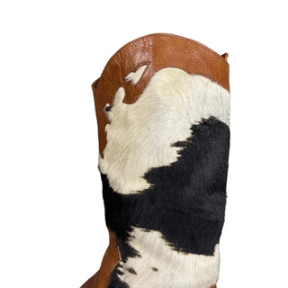 Cowhide rug with black and white pattern on a white floor