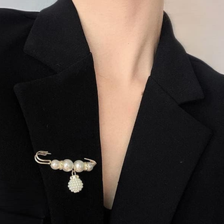 Pearl brooch on a black blazer