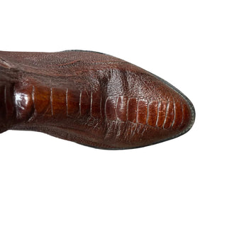 Brown leather boot sole on a wooden floor