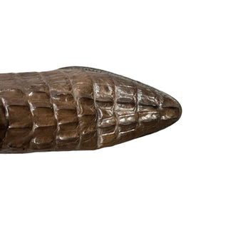 cowboy boot with a textured surface on a white floor