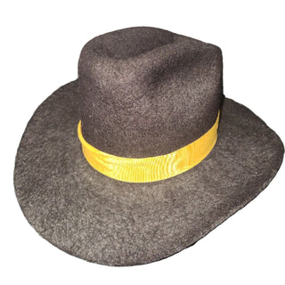 Brown hat with a yellow band on a white surface