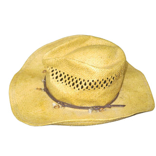 Yellow cowboy hat on a dark surface with a white background