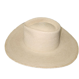 Beige straw hat on a black surface with white background