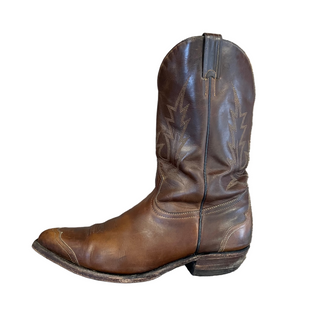 Brown leather boot on a wooden surface