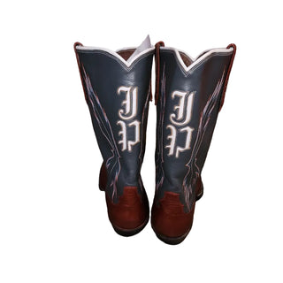 Pair of black and brown cowboy boots with white lettering on a white background