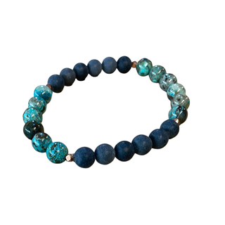 Bracelet with blue and green beads on a white background