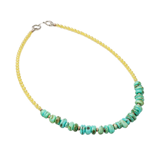 Necklace with turquoise beads on a yellow cord against a white background