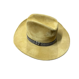 Beige wide-brimmed hat with a black band on a white surface
