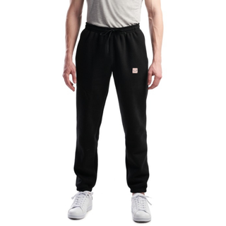 Person wearing black sweatpants with a logo on a white background