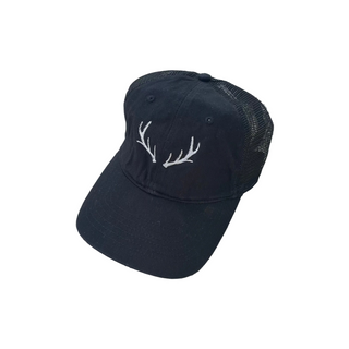 Black cap with white deer antlers on a white surface