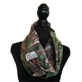 Camouflage infinity scarf on a mannequin with a visible brand logo against a white background