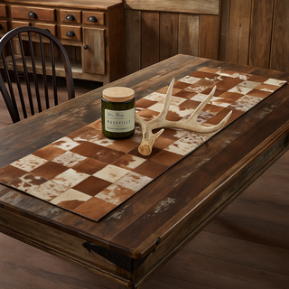 Candle and antlers on a checkered table runner in a rustic setting