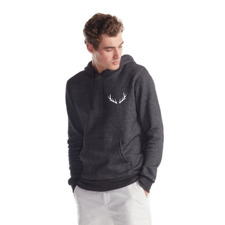 Man wearing a dark gray hoodie with a white antler design on a white background
