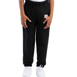 Black sweatpants worn by a kid on a white background