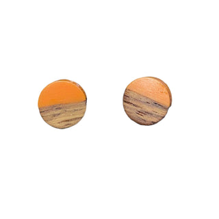 Pair of round wooden earrings with orange and brown color scheme on a white background