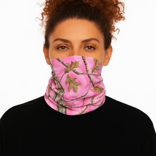 Person wearing a pink and green camouflage neck gaiter on a white background