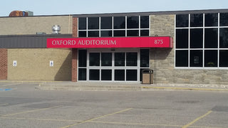 Building exterior with 'Oxford Auditorium' sign on a clear day