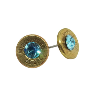 Gold earring studs with blue gemstones on a white background