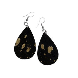 A pair of black cowhide earrings with gold speckled patterns, featuring surgical steel backings.