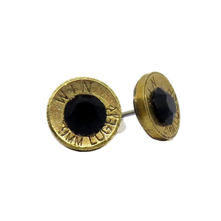 Gold bullet casing earrings with black centers on a white background