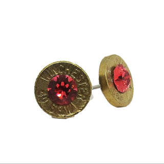 Gold earrings with red gemstones on a white background