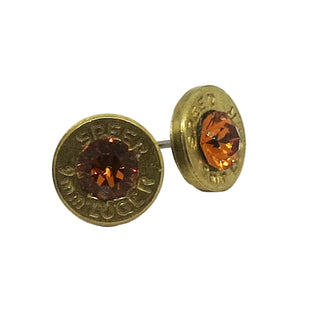 Bullet casing stud earrings with orange gemstones on a white background