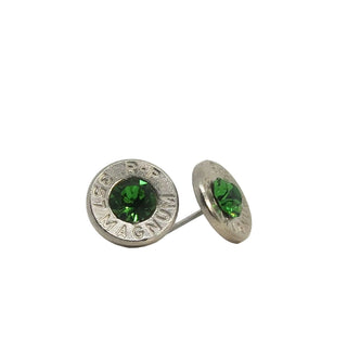 A pair of stud earrings made from recycled bullet casing with an emerald gemstone, set against a white background.